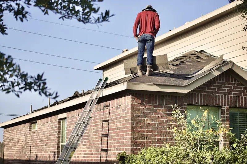 Professional roofer working on a residential roof in Hughson